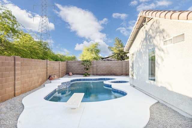 view of swimming pool featuring a fenced backyard, a fenced in pool, a diving board, and a patio