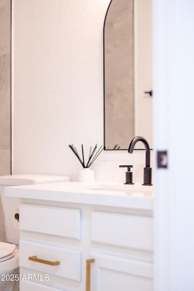 half bath featuring toilet and vanity