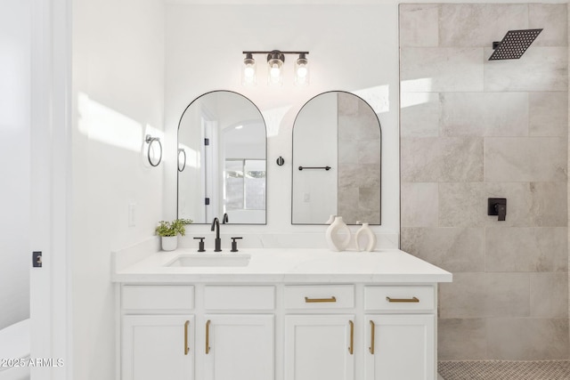 full bath featuring a walk in shower and vanity