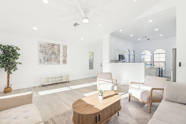 living room with visible vents, a ceiling fan, recessed lighting, and light wood-type flooring