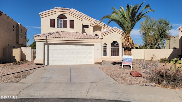 mediterranean / spanish home with stucco siding, concrete driveway, an attached garage, fence, and a tiled roof