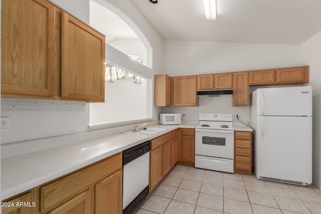 kitchen featuring lofted ceiling, white appliances, sink, and light tile patterned floors