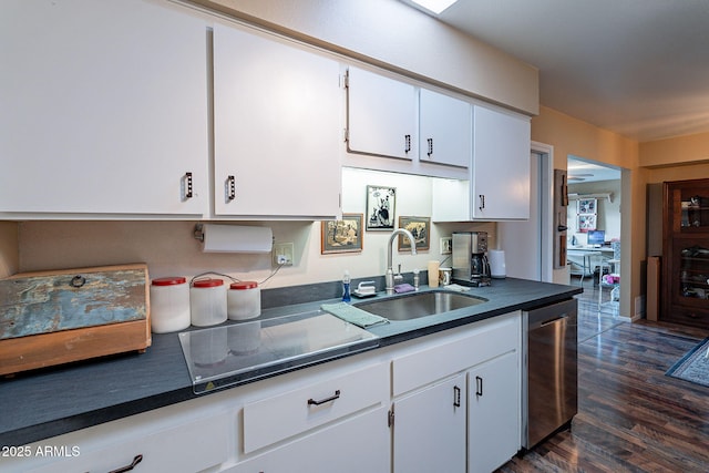 kitchen with stainless steel dishwasher, cooktop, sink, white cabinets, and dark hardwood / wood-style floors