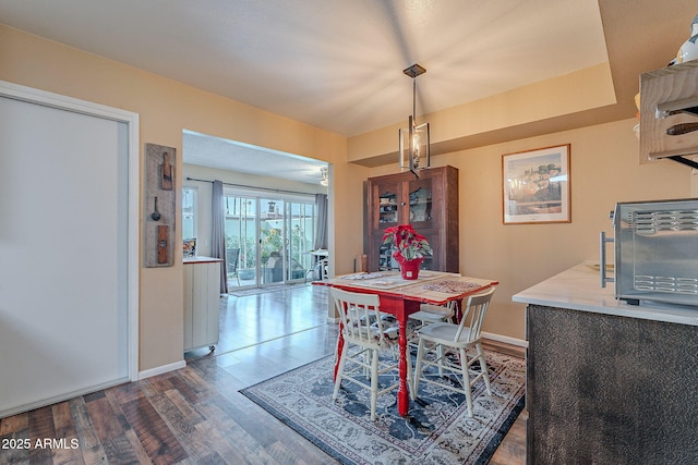 dining space with hardwood / wood-style flooring