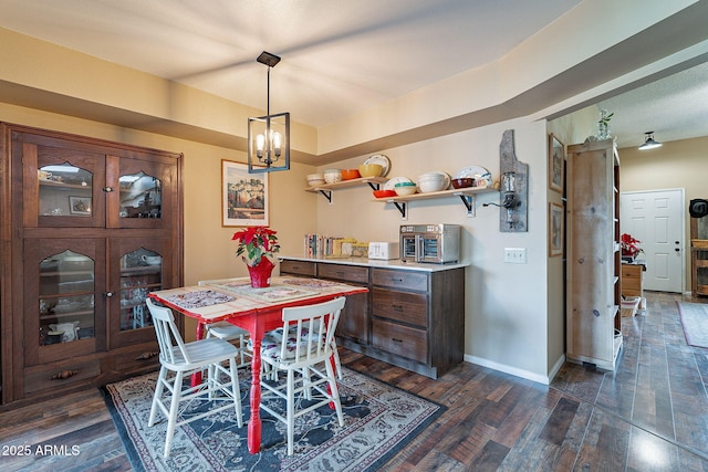 dining room featuring dark hardwood / wood-style floors and an inviting chandelier