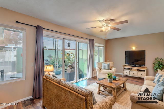 living room with ceiling fan, plenty of natural light, and hardwood / wood-style flooring