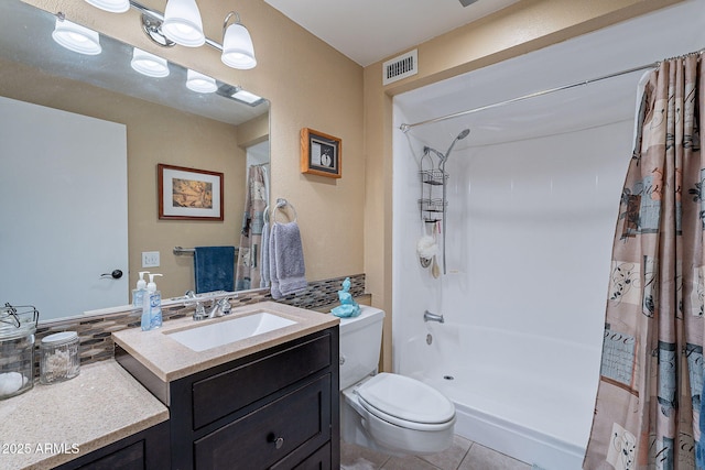 bathroom with tile patterned flooring, vanity, toilet, and backsplash