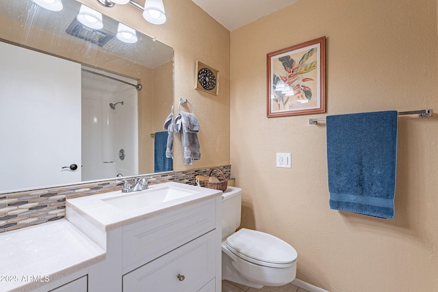 bathroom with decorative backsplash, toilet, a shower, and vanity