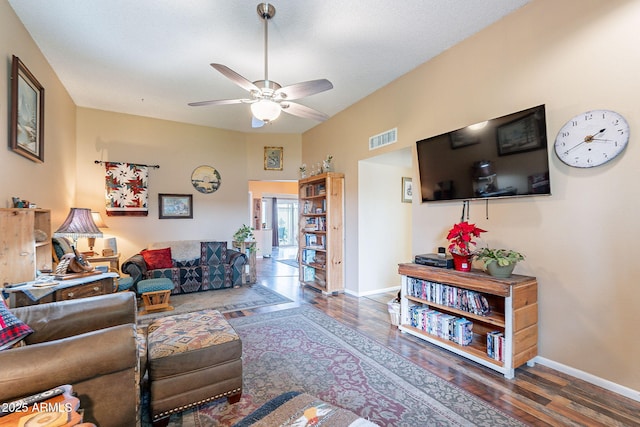 living room with dark hardwood / wood-style flooring and ceiling fan