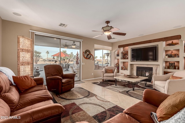 living room featuring ceiling fan and light tile patterned flooring