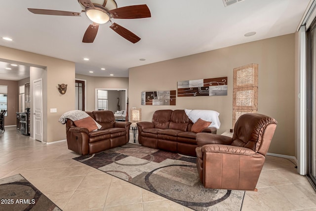 tiled living room with ceiling fan