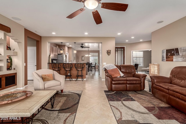 living room featuring light tile patterned floors and ceiling fan