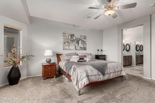 bedroom featuring ceiling fan, ensuite bathroom, and carpet floors