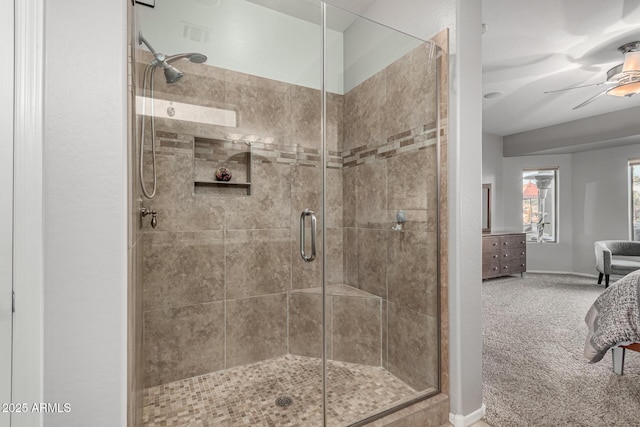 bathroom featuring ceiling fan and a shower with shower door