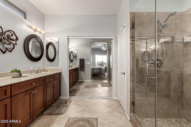 bathroom featuring a shower with door, vanity, and tile patterned floors