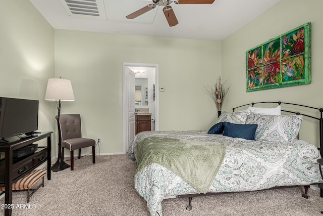 bedroom with ensuite bath, ceiling fan, and carpet