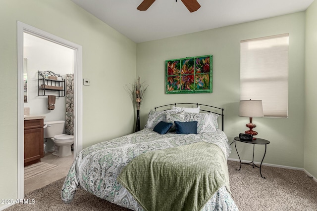 carpeted bedroom featuring ceiling fan and connected bathroom