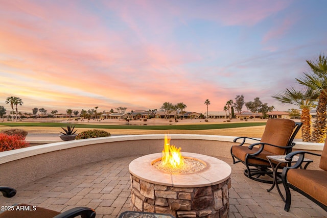 patio terrace at dusk featuring a fire pit