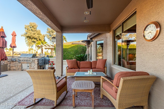 view of patio featuring an outdoor living space, a grill, and an outdoor kitchen