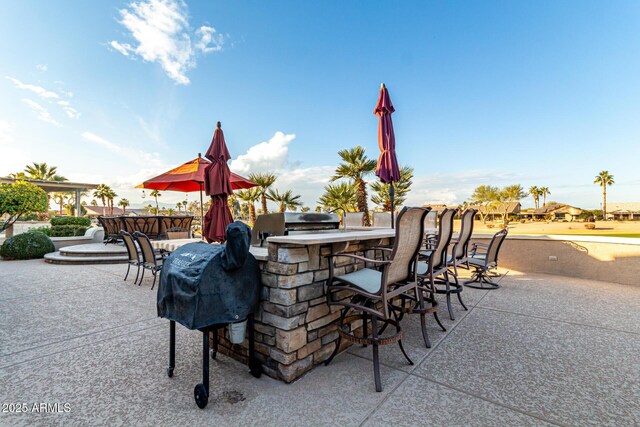 view of patio featuring exterior bar and area for grilling