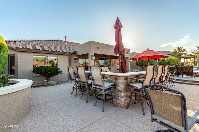 patio terrace at dusk with an outdoor bar