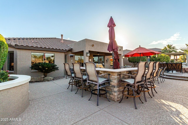 view of patio featuring exterior bar