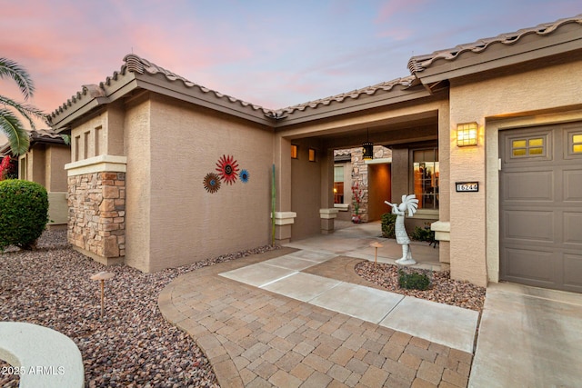 exterior entry at dusk with a porch