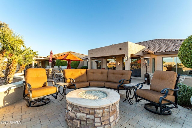 view of patio featuring an outdoor living space with a fire pit