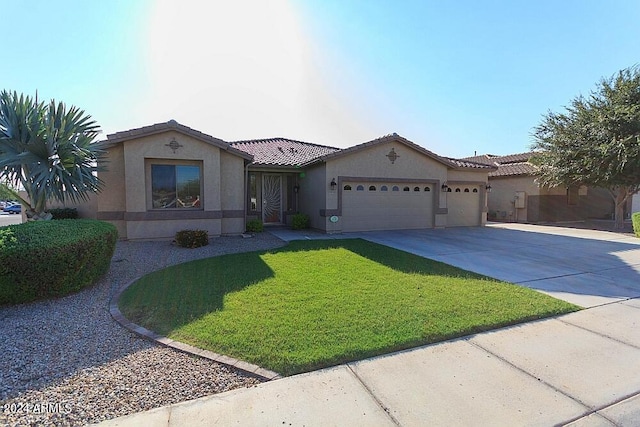 mediterranean / spanish-style home with a garage and a front lawn