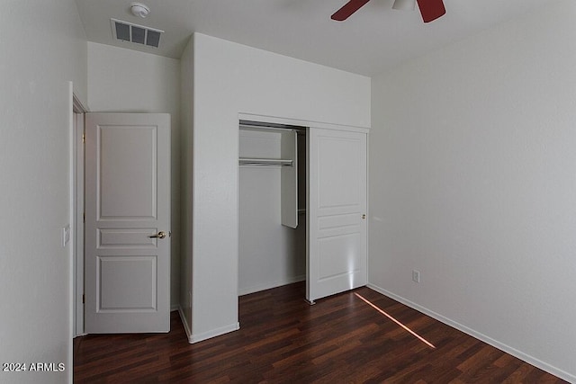 unfurnished bedroom featuring a closet, dark hardwood / wood-style floors, and ceiling fan