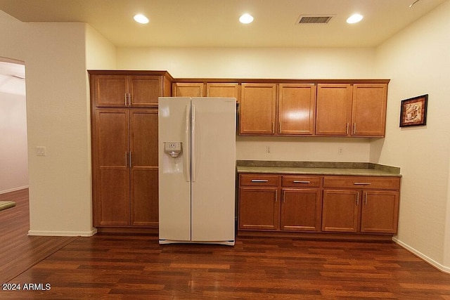 kitchen featuring dark hardwood / wood-style flooring and white refrigerator with ice dispenser