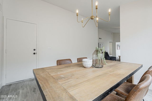 dining room with a notable chandelier and wood finished floors