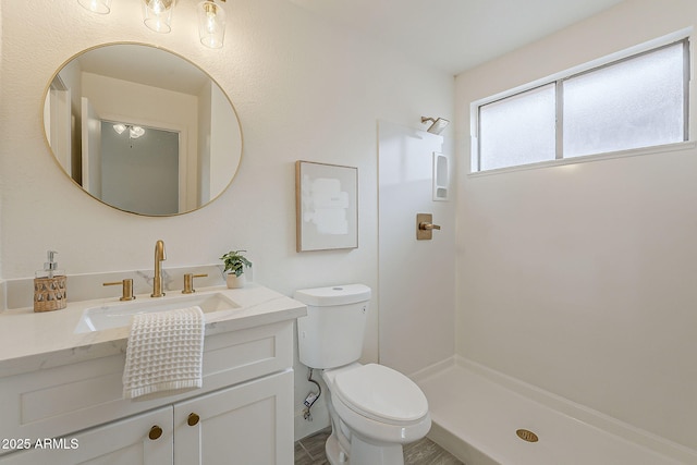 full bathroom with toilet, vanity, and walk in shower