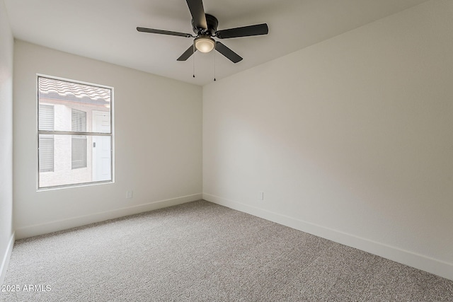 carpeted empty room with baseboards and ceiling fan