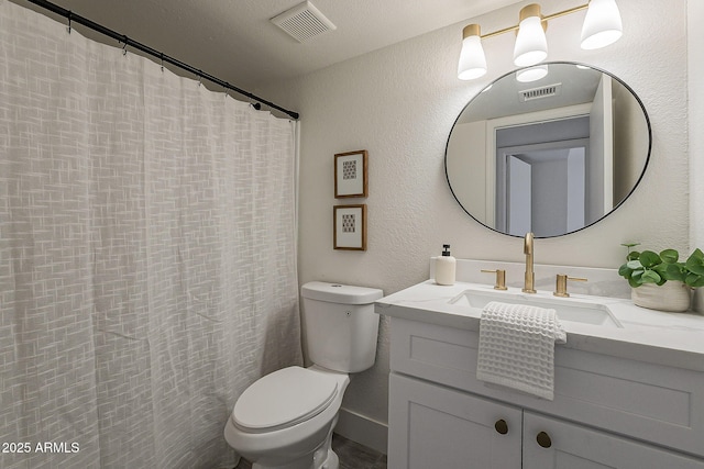 full bathroom featuring visible vents, toilet, vanity, and a textured wall