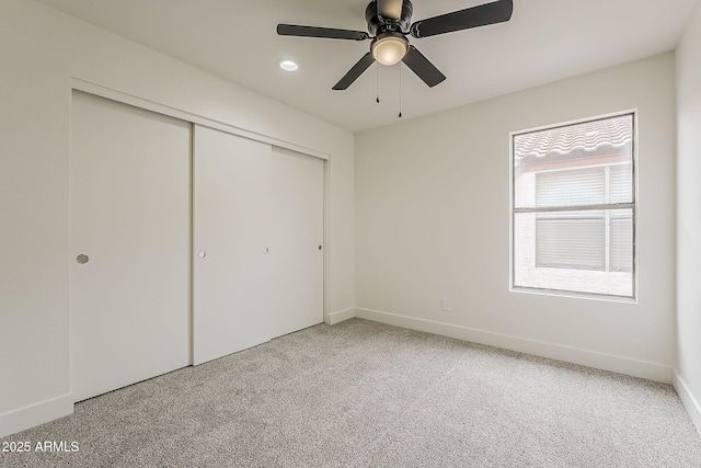 unfurnished bedroom with baseboards, carpet floors, recessed lighting, ceiling fan, and a closet