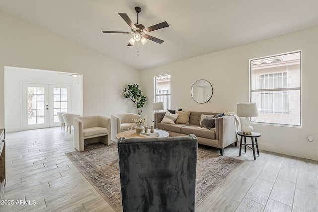 living area with wood finish floors, plenty of natural light, and ceiling fan