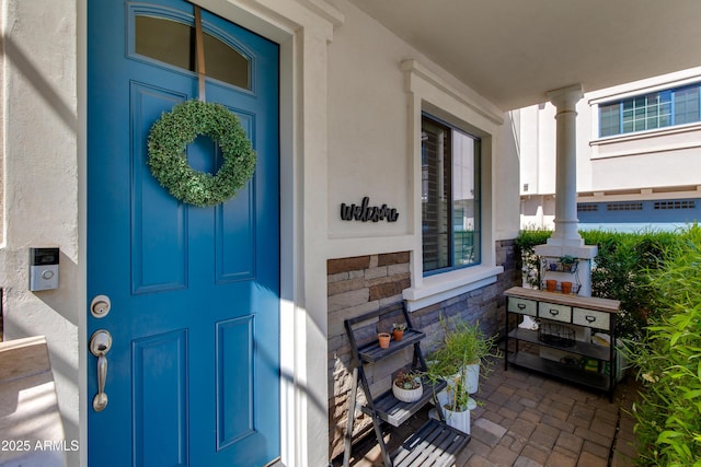 4438 N 27th St Unit 27, Phoenix, AZ 85016 - doorway to property with stucco siding, stone siding, and covered porch