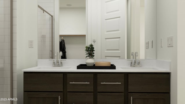 bathroom featuring a sink, double vanity, and a stall shower
