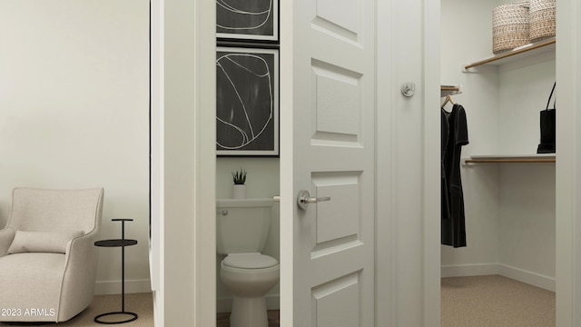 bathroom featuring toilet and baseboards