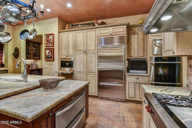7710 E Golden Eagle Cir, Gold Canyon, AZ 85118 - kitchen with appliances with stainless steel finishes, a sink, stone tile flooring, range hood, and recessed lighting