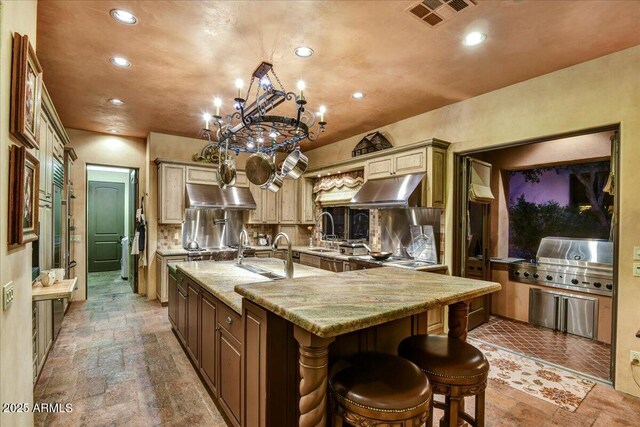 7710 E Golden Eagle Cir, Gold Canyon, AZ 85118 - kitchen with stone tile floors, recessed lighting, under cabinet range hood, and a sink