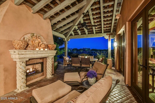 7710 E Golden Eagle Cir, Gold Canyon, AZ 85118 - view of patio featuring a warm lit fireplace, a gazebo, and outdoor dining space