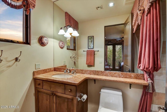 7710 E Golden Eagle Cir, Gold Canyon, AZ 85118 - bathroom with vanity, toilet, recessed lighting, and ceiling fan