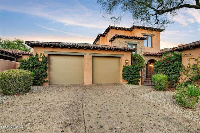 7710 E Golden Eagle Cir, Gold Canyon, AZ 85118 - mediterranean / spanish-style house featuring a tiled roof, driveway, stucco siding, and an attached garage