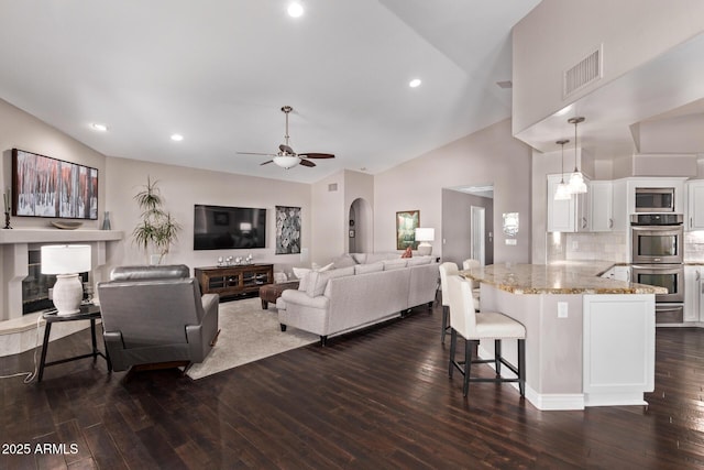 3733 E Kachina Dr, Phoenix, AZ 85044 - living room featuring dark wood finished floors, a ceiling fan, recessed lighting, and high vaulted ceiling