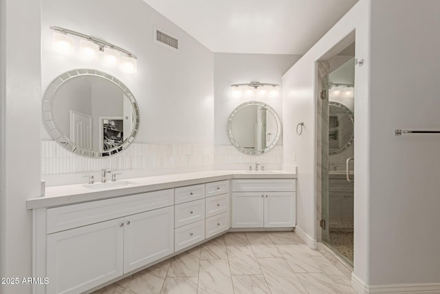 3733 E Kachina Dr, Phoenix, AZ 85044 - full bath with marble look tile flooring, double vanity, a shower stall, and tasteful backsplash