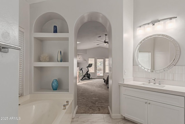 3733 E Kachina Dr, Phoenix, AZ 85044 - full bath with ceiling fan, marble look tiles, vanity, built in shelves, and a garden tub
