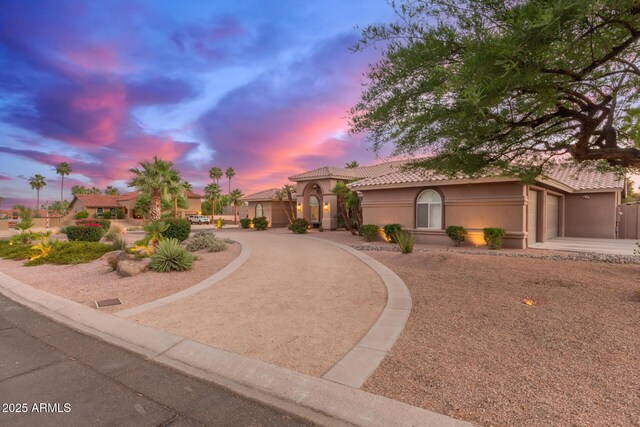 3733 E Kachina Dr, Phoenix, AZ 85044 - mediterranean / spanish house with driveway, a garage, stucco siding, and a tiled roof