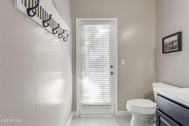 3733 E Kachina Dr, Phoenix, AZ 85044 - bathroom with toilet, baseboards, tile patterned flooring, and vanity